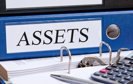 Blue binder labeled with "Assets".