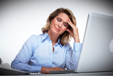 a stressed woman using a laptop