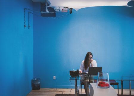 a woman working in a blue office
