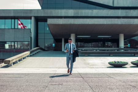 a businessman leaving a claims managementoffice.