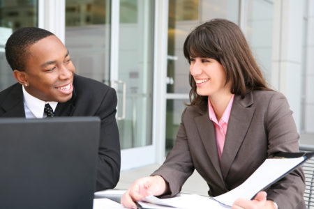 a man and a woman in suits having a meeting