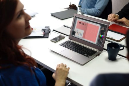a woman using a laptop in a office