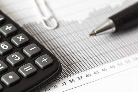a calculator on a balance sheet