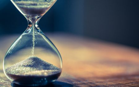 Sand running through the bulbs of an hourglass measuring the passing time in a countdown to PPI claims deadline