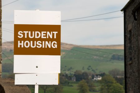 Orange and white student housing sign used for landlords' property management.