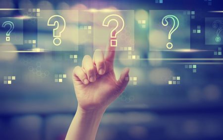 Question marks with hand pressing a button.