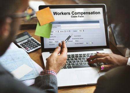 Worker's compensation claim form shown on a laptop..