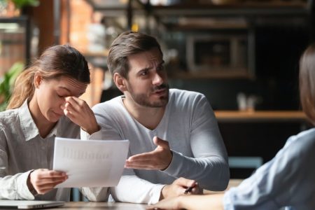 man and woman frustrated with mortgage