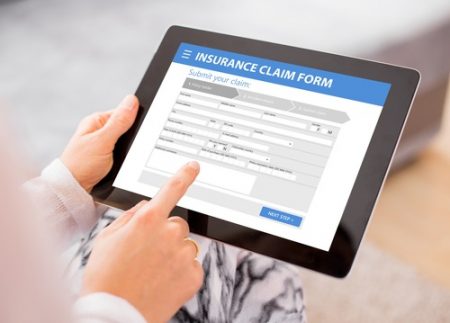 an image of a insurance claim form being filled in on a tablet.
