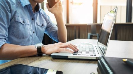 a man handling claims on his laptop